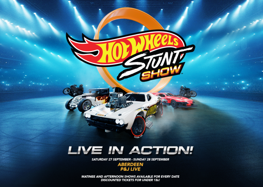 Some of the cars and bikes used in the Hot Wheels Stunt Show sitting in an arena.x